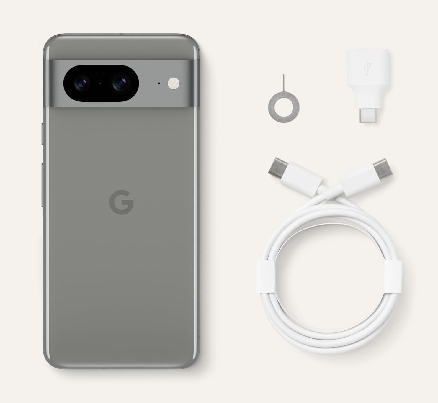 Pixel 8 in Hazel beside a SIM tool, a Quick Switch adaptor and a coiled USB-C to USB-C cable